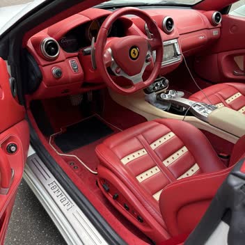 The red leather interior of a Ferrari California after a full interior detail.