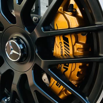 An AMG wheel with yellow ceramic brake calipers after cleaning.