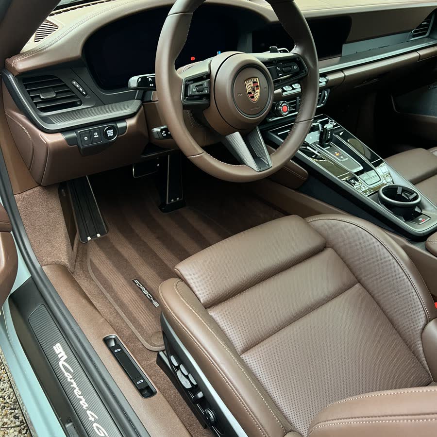 A cleaned Porsche interior with tan leather and open-pore trim.